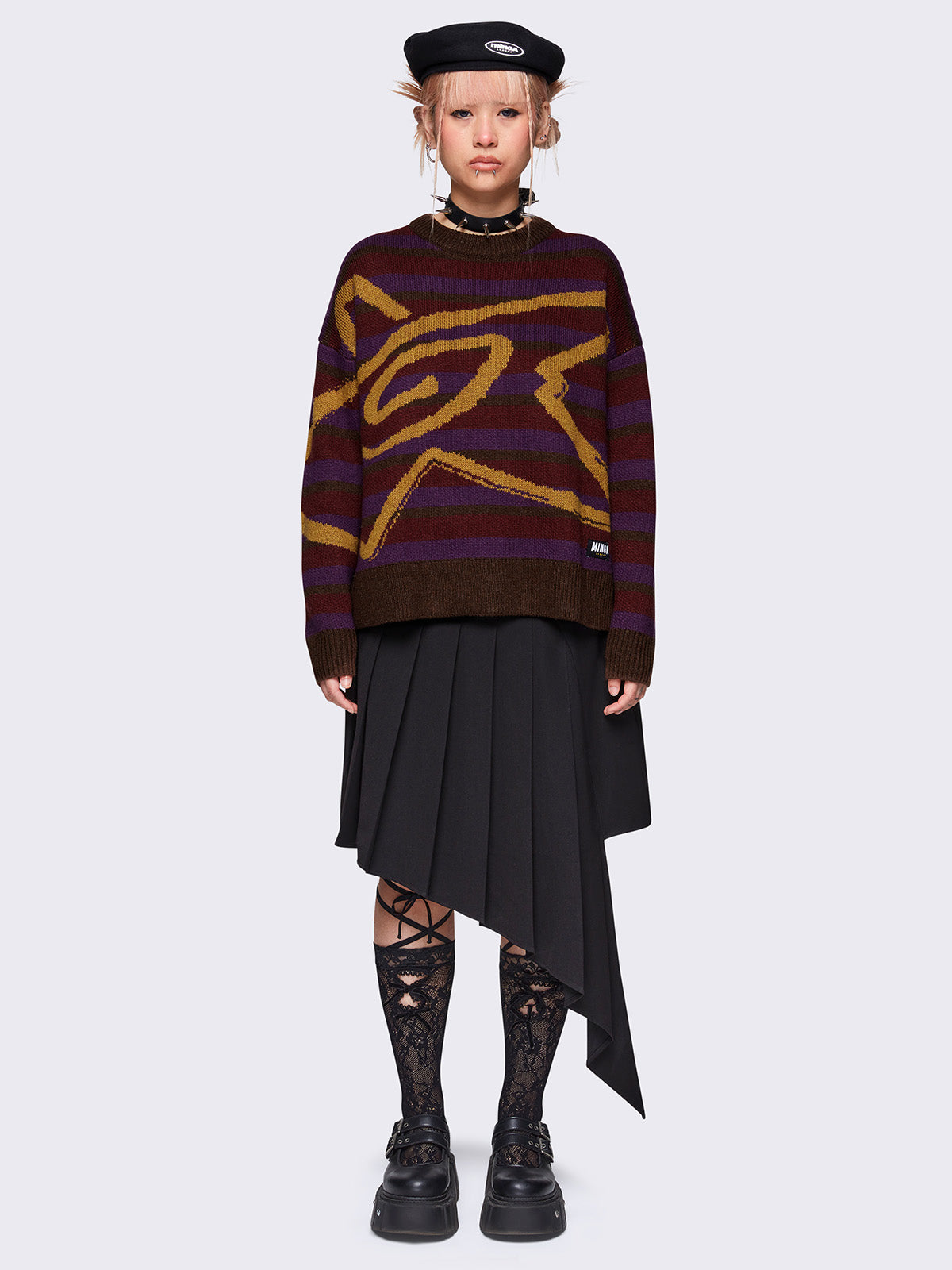 Striped knit jumper in brown, burgundy and purple with a swirl star design in orange and a loose fit.