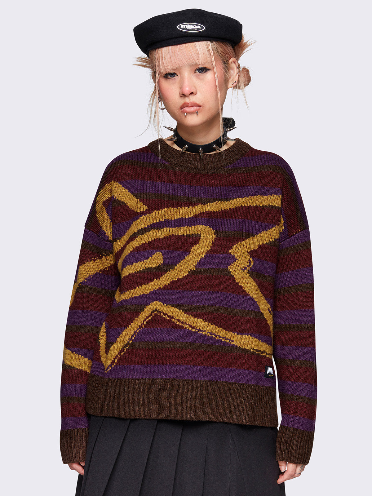 Striped knit jumper in brown, burgundy and purple with a swirl star design in orange and a loose fit.