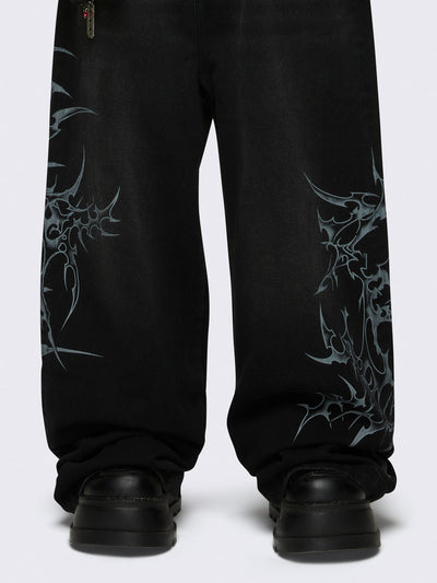 Baggy jeans in black with sigilism graphic print