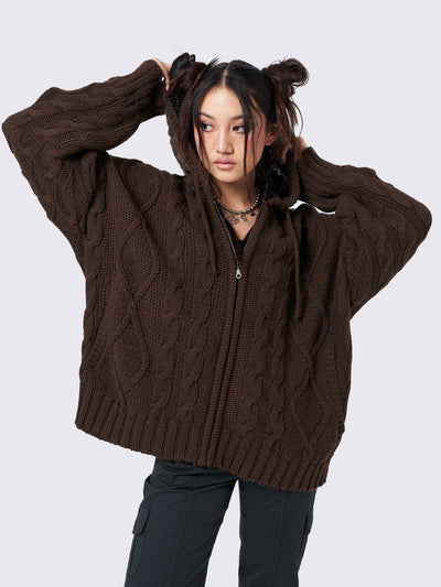 Oversized brown cable knit hooded cardigan with zip fastening and side pockets.