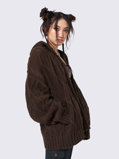 Oversized brown cable knit hooded cardigan with zip fastening and side pockets.