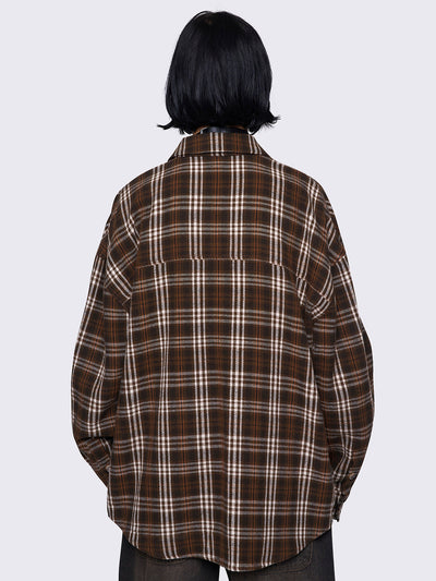 Plaid shirt in brown tones with a front button placket, chest pocket, and spread collar. Designed with long sleeves and a loose fit 