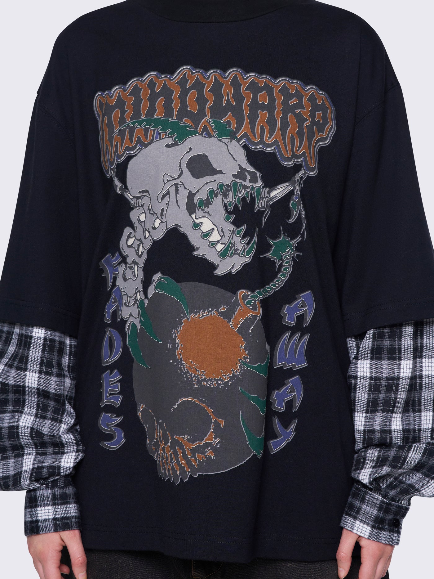 Black layered long sleeve t-shirt with contrast black and grey plaid sleeves, Mindwarp graphic front print, crew neck, and relaxed fit.