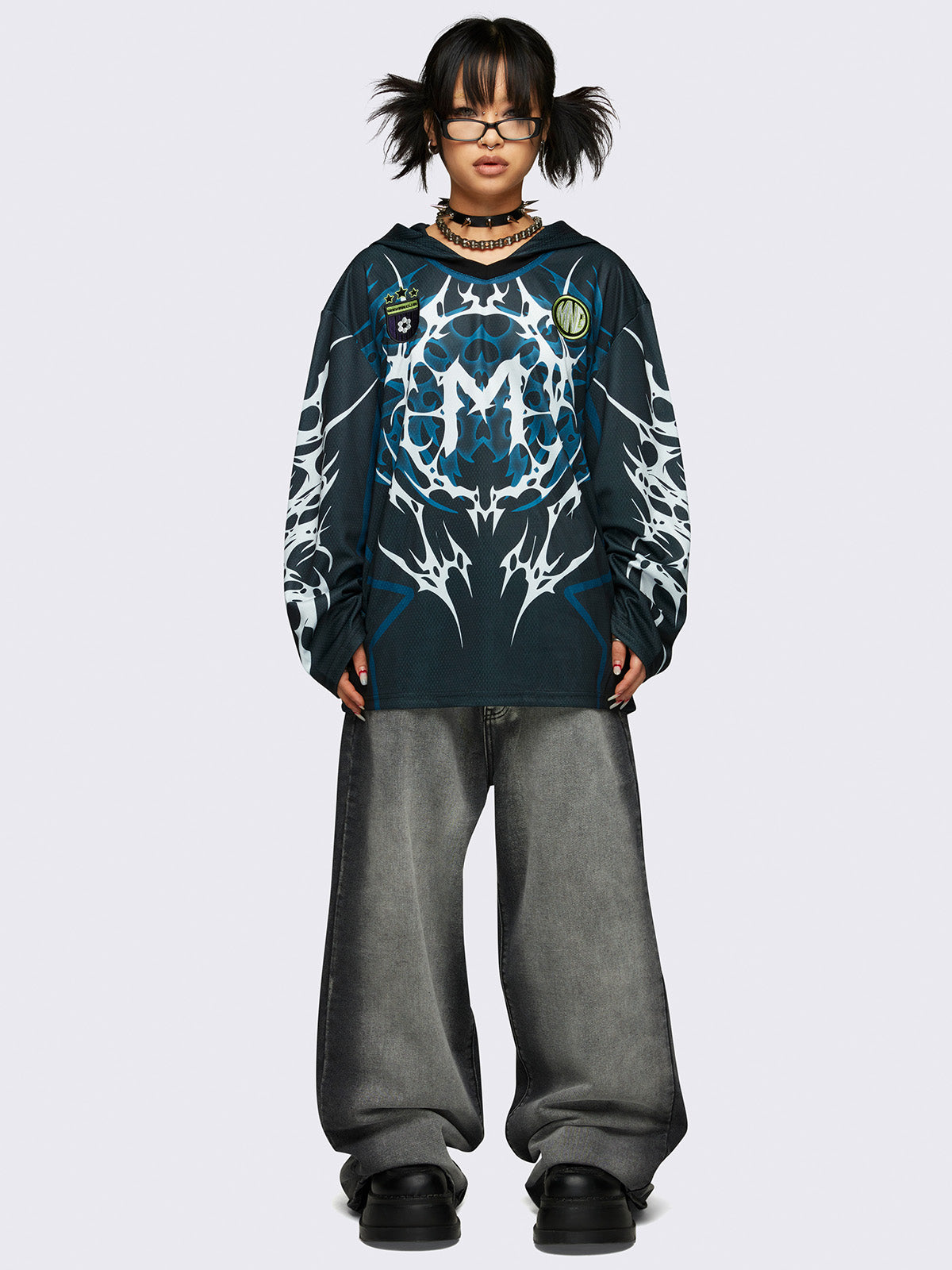 Football jersey hoodie in black with tribal graphic print in white and blue