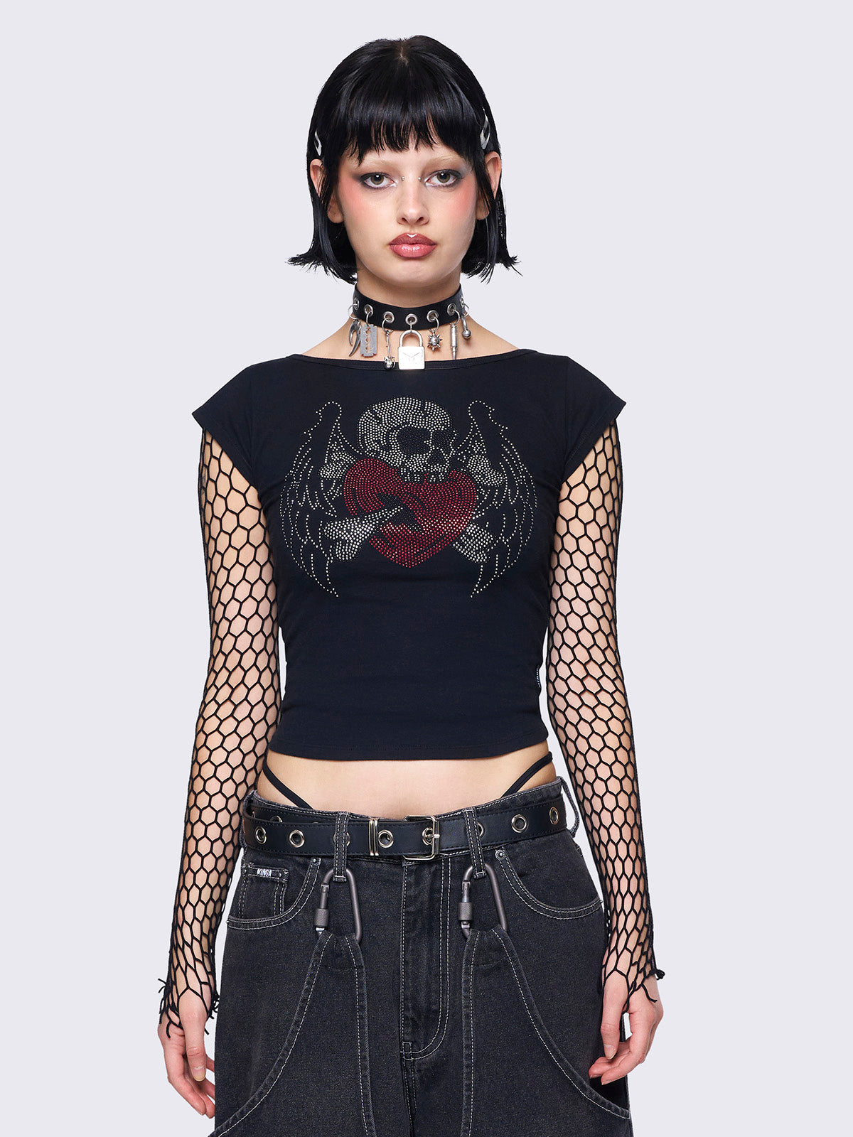 Black capped sleeve tee featuring a skull heart rhinestone graphic, slim fit, and a rounded neckline.