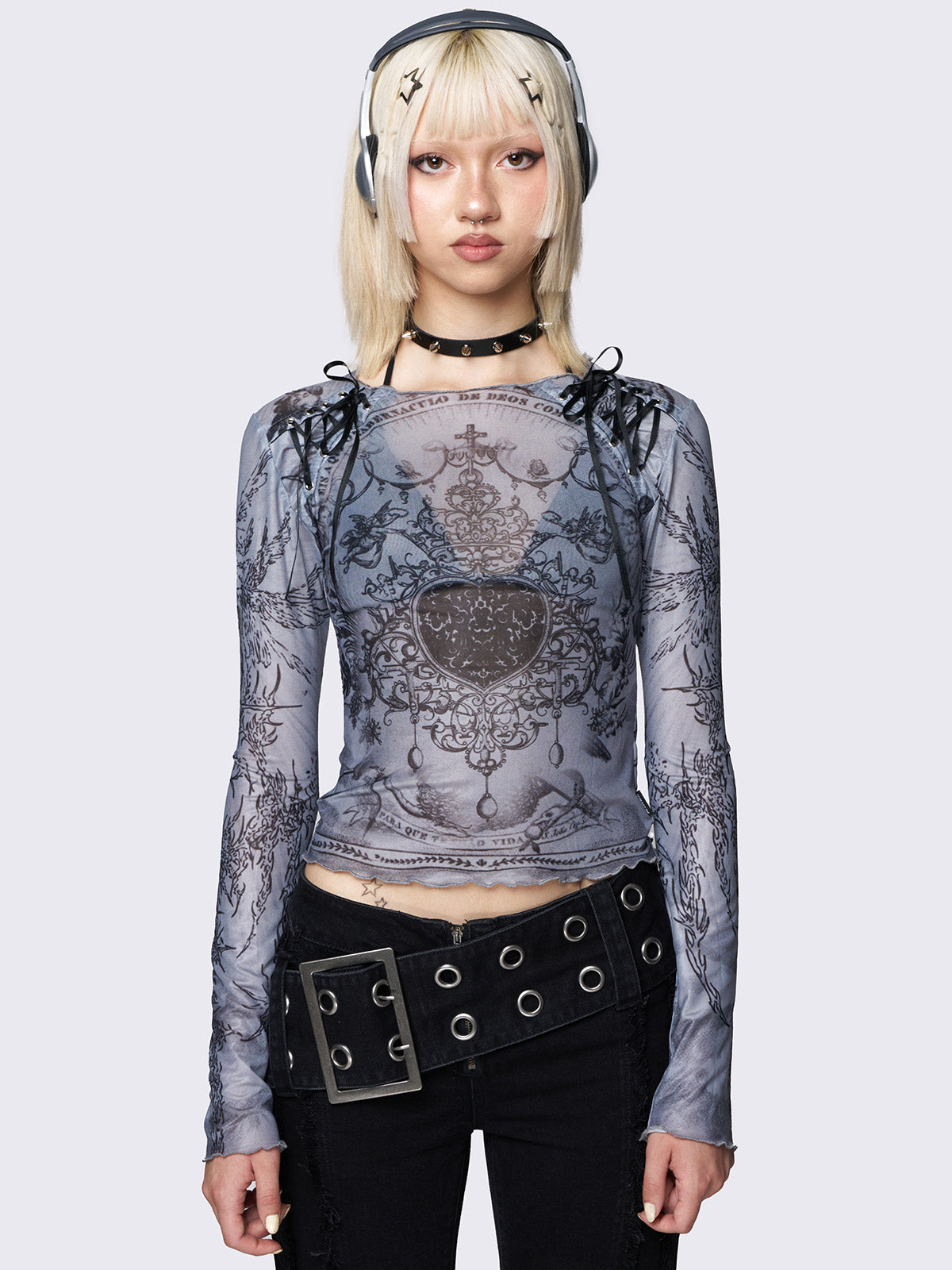 Grey printed mesh crop top with an all-over graphic print, black lace-up details, and reverse stitching for an edgy touch.