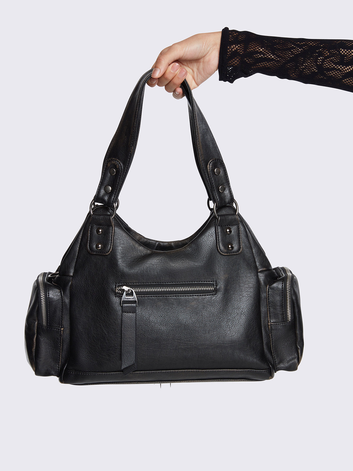 Washed black faux leather shoulder bag featuring studded cross patches, spike and chain accents, and multiple pockets.