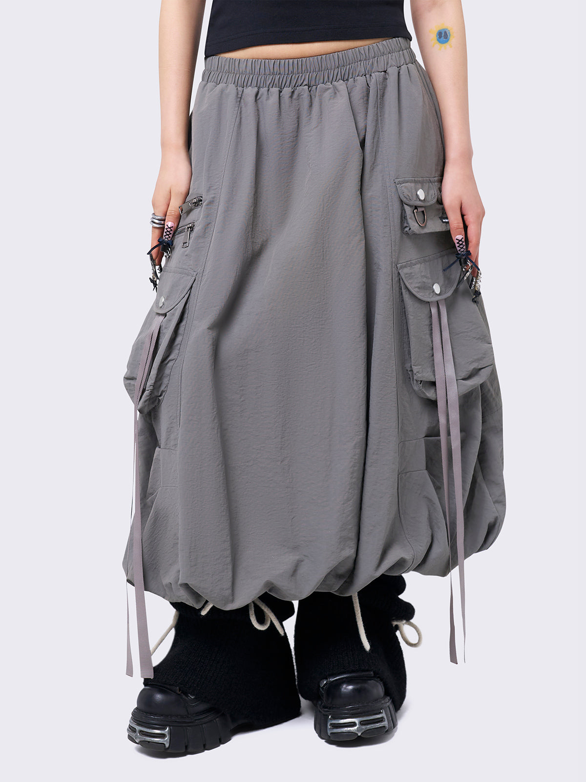 Grey bubble midi skirt featuring balloon style and utility cargo pockets with straps.