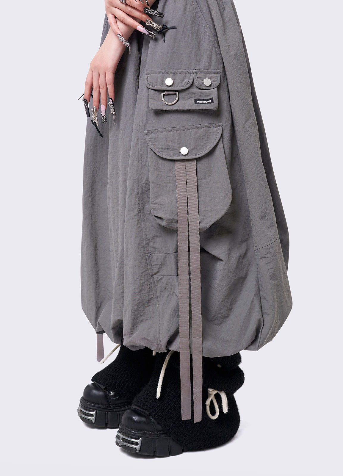 Grey bubble midi skirt featuring balloon style and utility cargo pockets with straps.