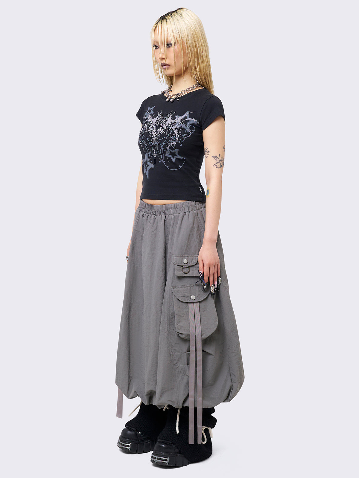 Grey bubble midi skirt featuring balloon style and utility cargo pockets with straps.