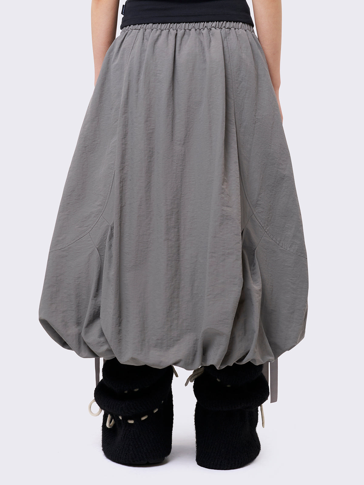 Grey bubble midi skirt featuring balloon style and utility cargo pockets with straps.