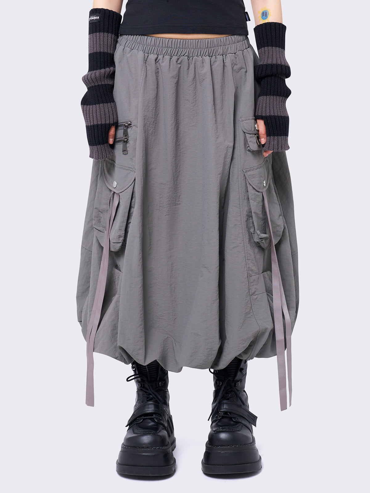 Grey bubble midi skirt featuring balloon style and utility cargo pockets with straps.