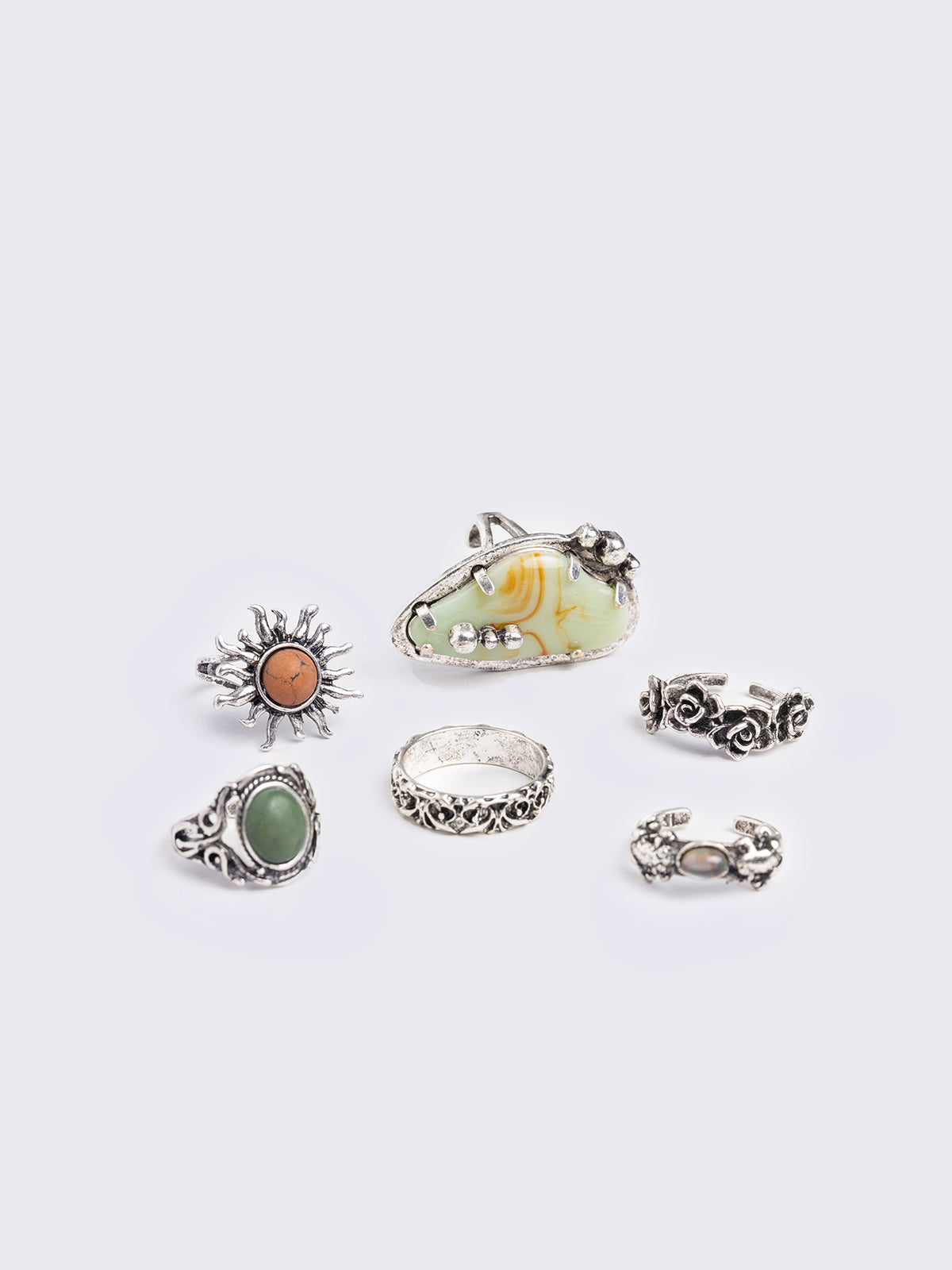 Set of 6 rings featuring orange and green stones and mixed engraved designs. Boho-fairy style.