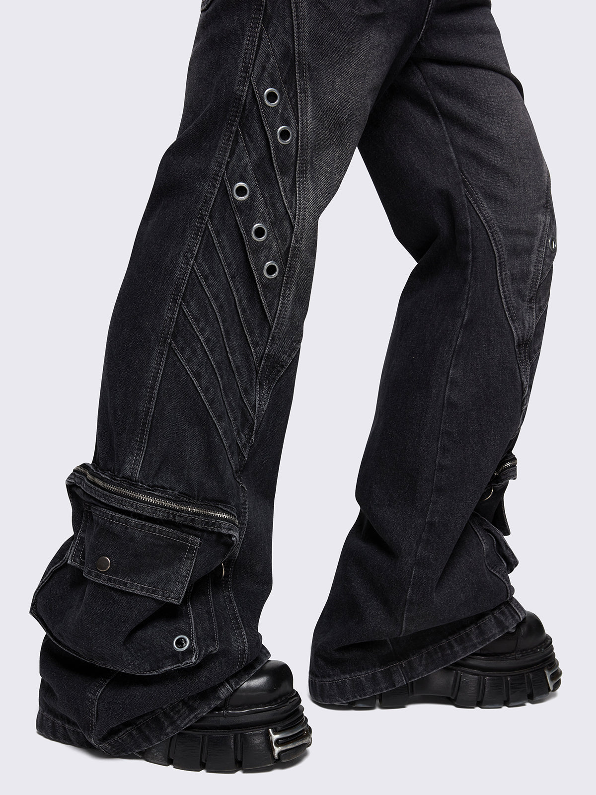 Black washed flare baggy jeans with grey overdye, twist seams, eyelet details and utility ankle pockets.