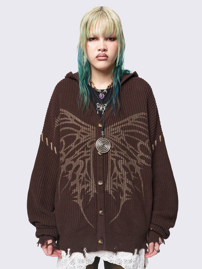 Brown chunky knit hooded cardigan featuring a dark beige butterfly graphic on the front. Includes contrast lace-up details and distressed trims for a fairy core stylish, edgy look.