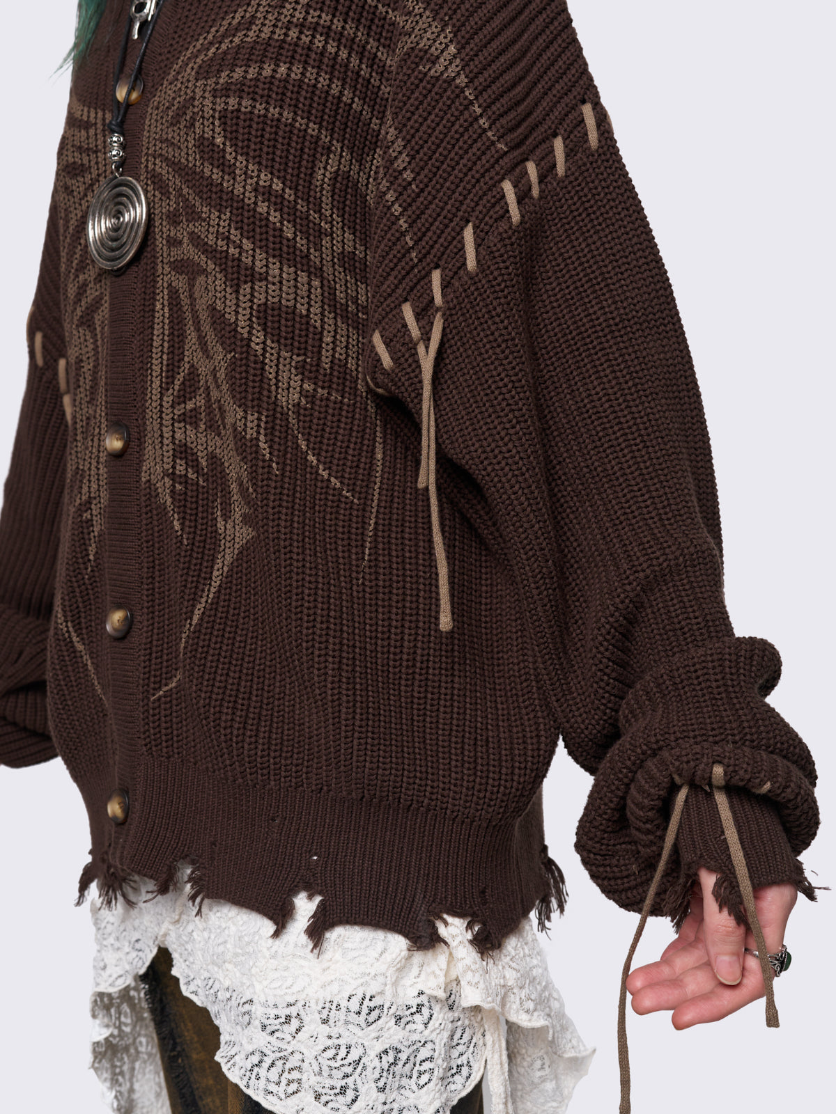 Brown chunky knit hooded cardigan featuring a dark beige butterfly graphic on the front. Includes contrast lace-up details and distressed trims for a fairy core stylish, edgy look.