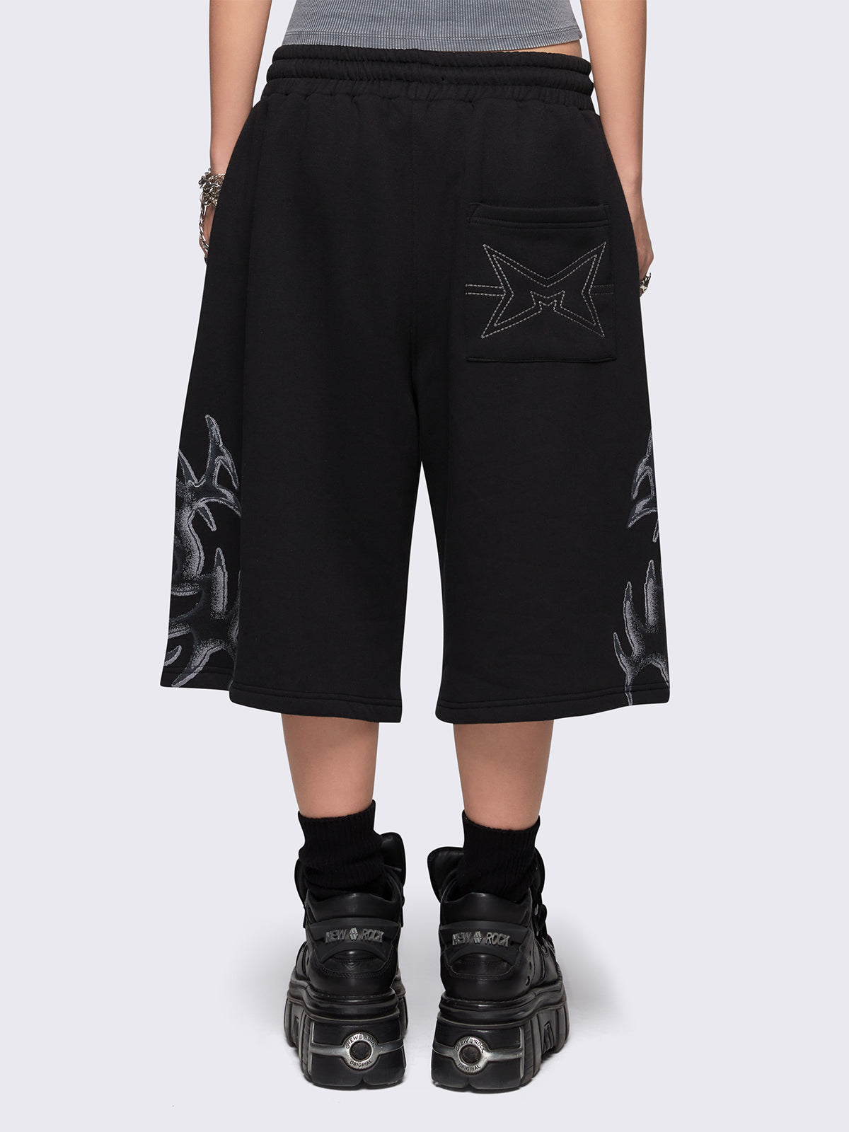 Black oversized longline sweat shorts with sigilism graphic print.