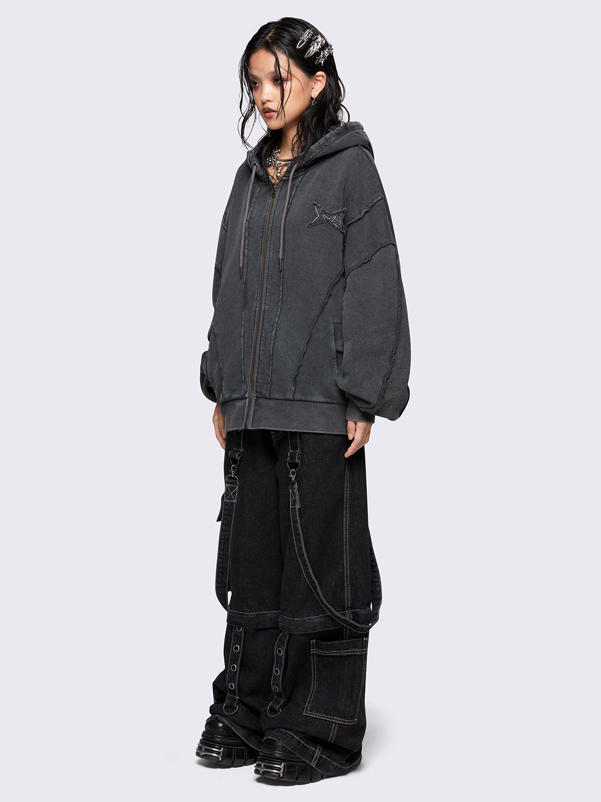 Washed grey oversized zip-up hoodie with exposed seam detailing, embroidered star patch on the chest, drawstring hood and ribbed cuffs and hem.