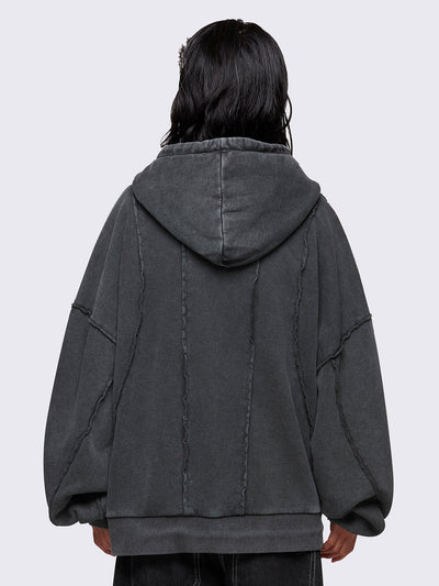 Washed grey oversized zip-up hoodie with exposed seam detailing, embroidered star patch on the chest, drawstring hood and ribbed cuffs and hem.