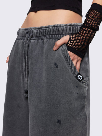 Grey washed longline sweat shorts featuring a distressed details, signature embroidered back pocket detail, elasticated drawstring waist and oversized fit.