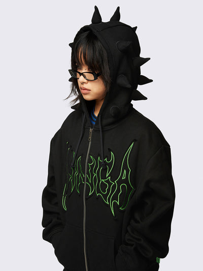 Black zip-up hoodie jacket featuring 3D spikes, green Minga embroidery, a drawstring hood, and zip fastening.