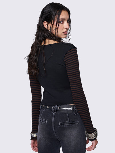 Long sleeve top in black featuring contrast sleeves in brown and black ribbed stripes and front striped butterfly patch