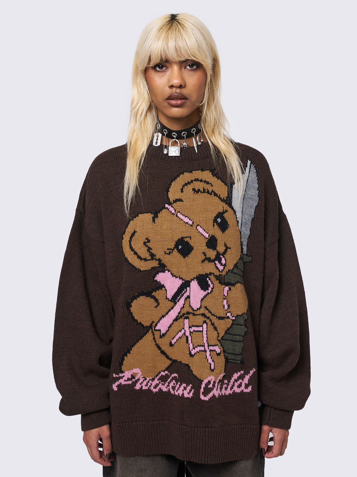 Jacquard knitted jumper in brown with "Problem Child" Teddy Bear front graphic design.