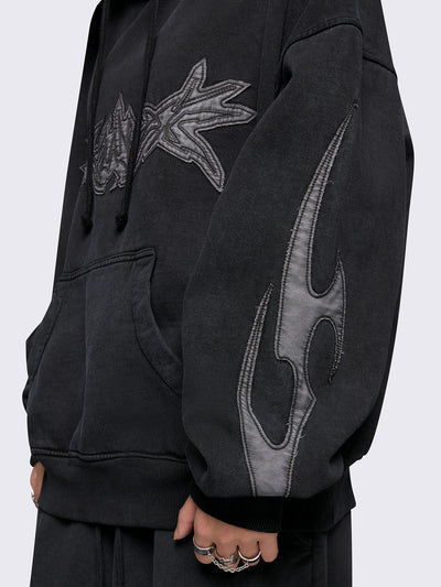 Black washed hoodie with grey sigilism embroidered patches, drawstring hood, and kangaroo pockets.