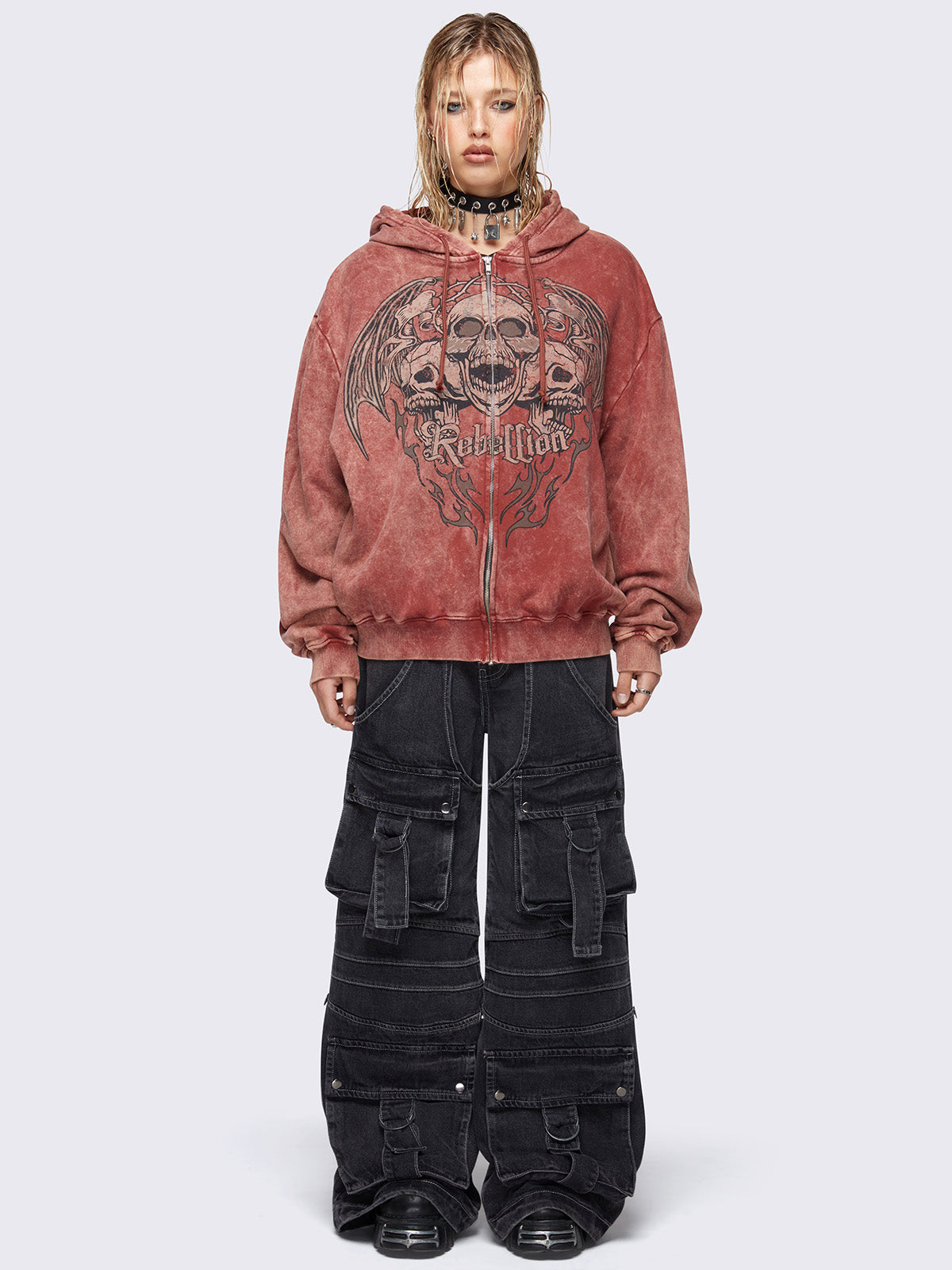 Zip up hoodie jacket in washed terracota red with rebellion skull graphic front print and drawstring hood.