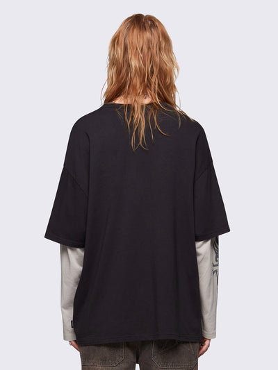 Black layered long sleeve t-shirt with grunge graphic front print and off-white contrast sleeves with cross print. Relaxed fit and crew neck.