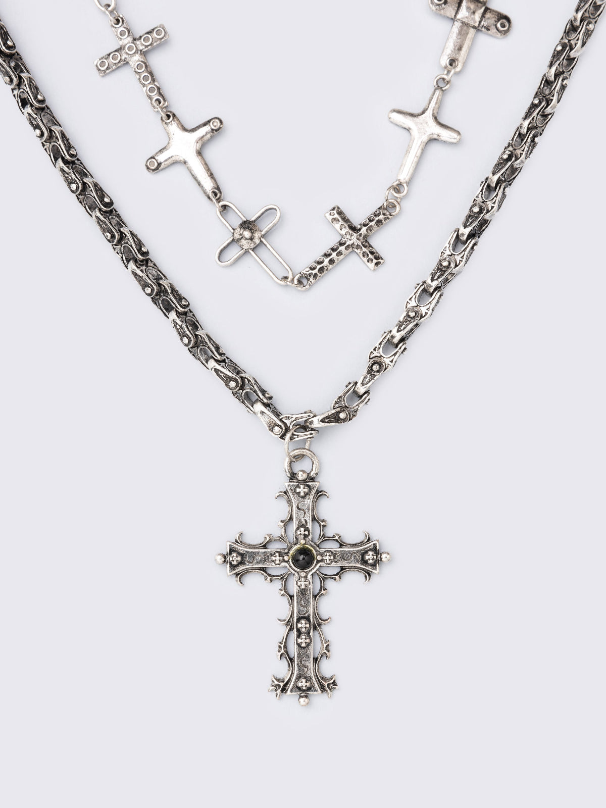 Set of 2 silver necklaces: one chunky chain with a bold cross pendant and another sturdy chain featuring multiple cross charms.