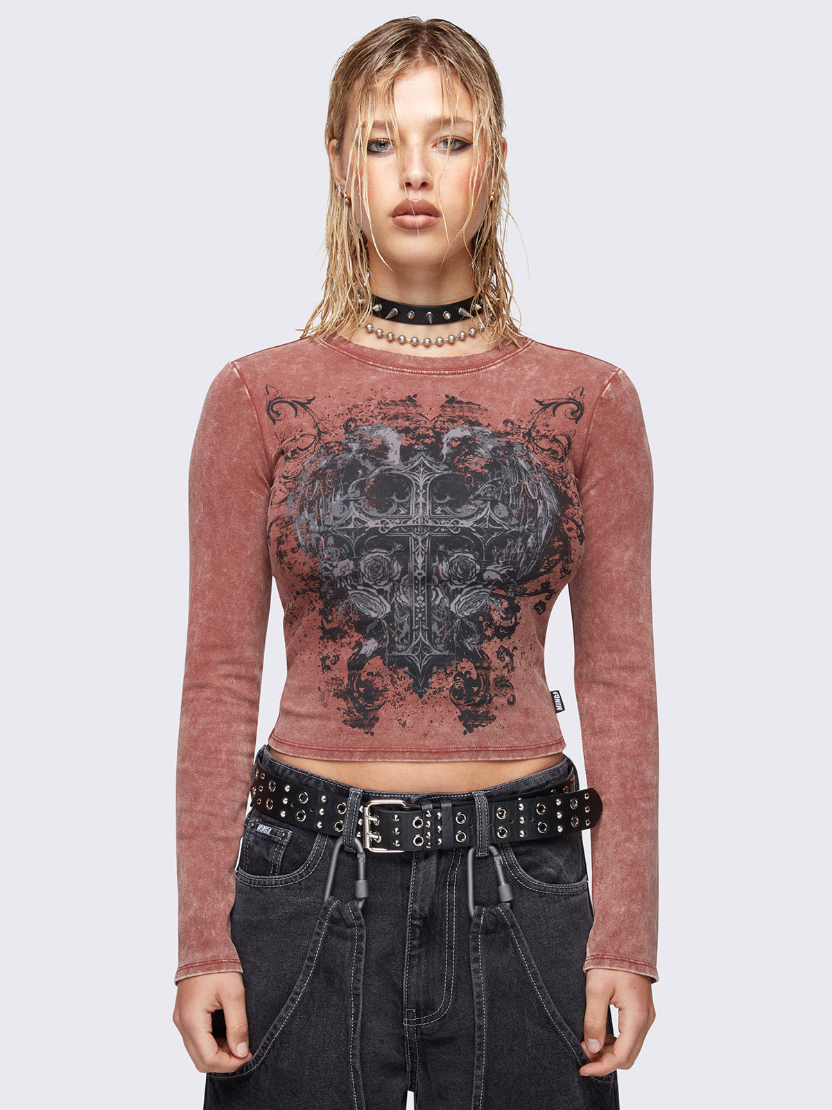 Slim fit long sleeve top in washed terracotta red. Winged cross front graphic print and rounded neckline