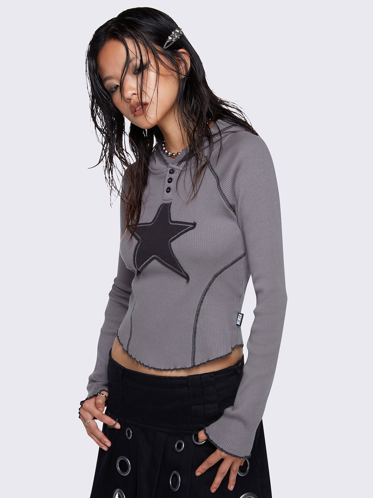 Hooded top in grey, with front star patch in black, contrast stitching in black and half button placket