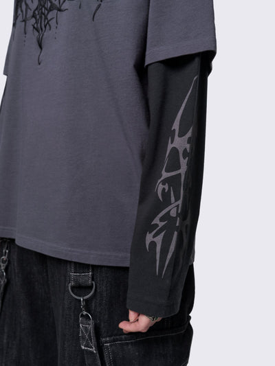 Layered long sleeve t-shirt in grey with contrast sleeves in black and sigilism graphic front and sleeves.